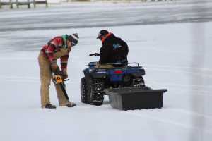 Checking ice with chainsaw