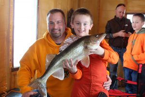 Father and son ice fishing with walleye, Lake of the Woods MN