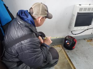 Joe Henry ice fishing with Vexilar in a fish house