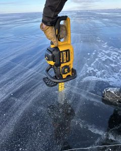 Checking ice for ice fishing