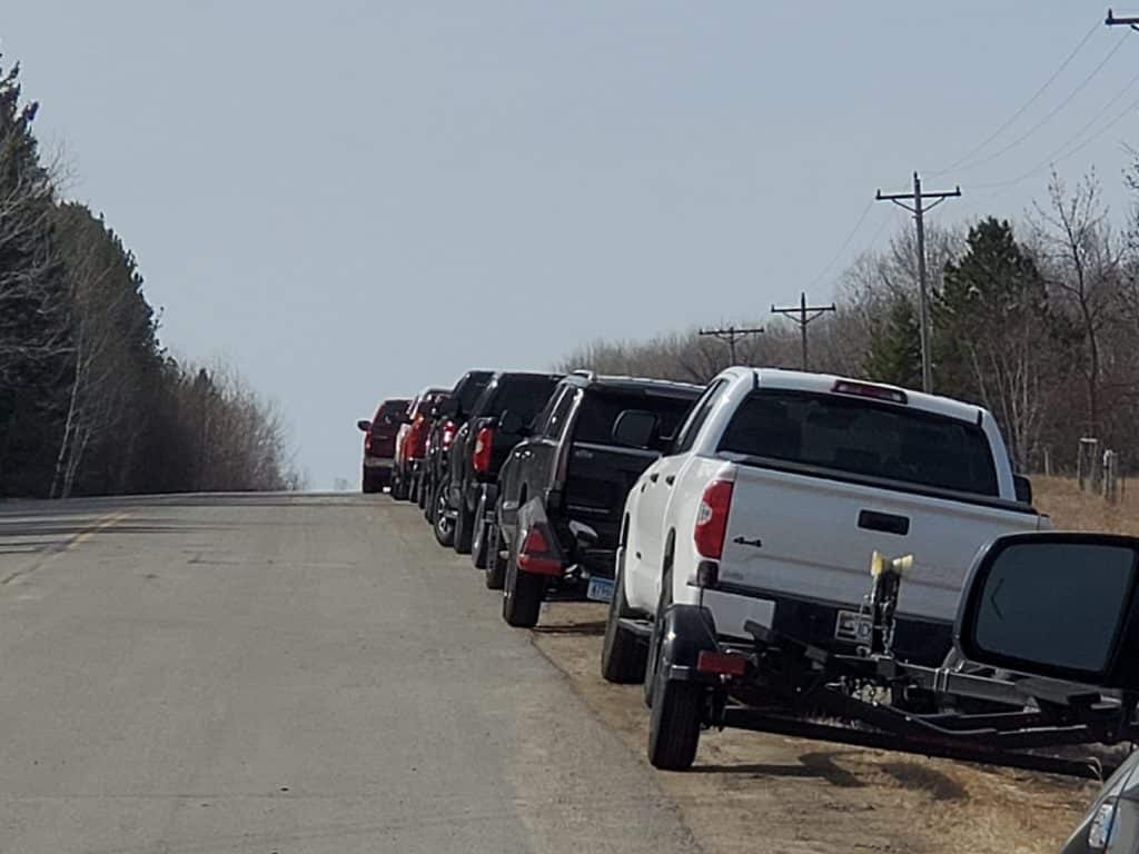 Trucks and trailers parked for spring fishing on the Rainy River