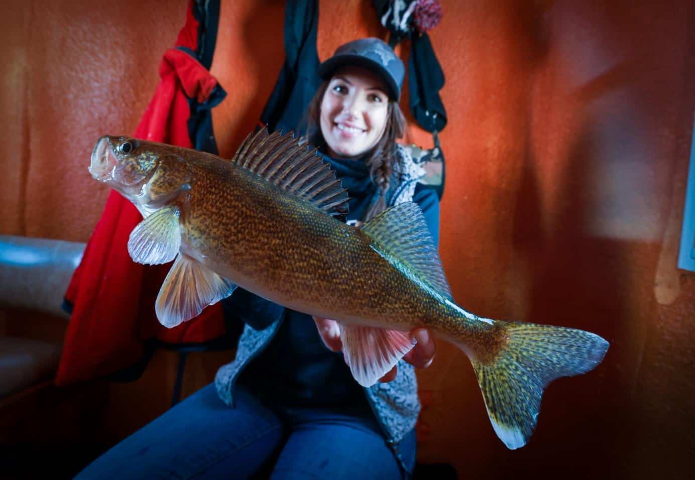 Jen Pudenz with nice walleye in fish house Cyrus Flag Island Resort 010625 2