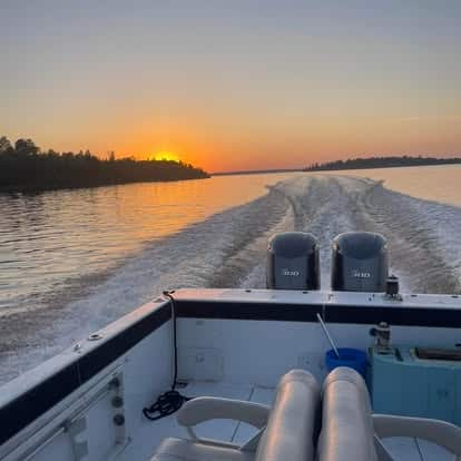 Lake-of-the-Woods-Passenger-Service-charter-boat-running-at-sunset.