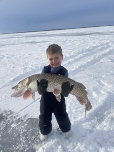 This big Pike caught is bigger than this boy What a great fishing report.