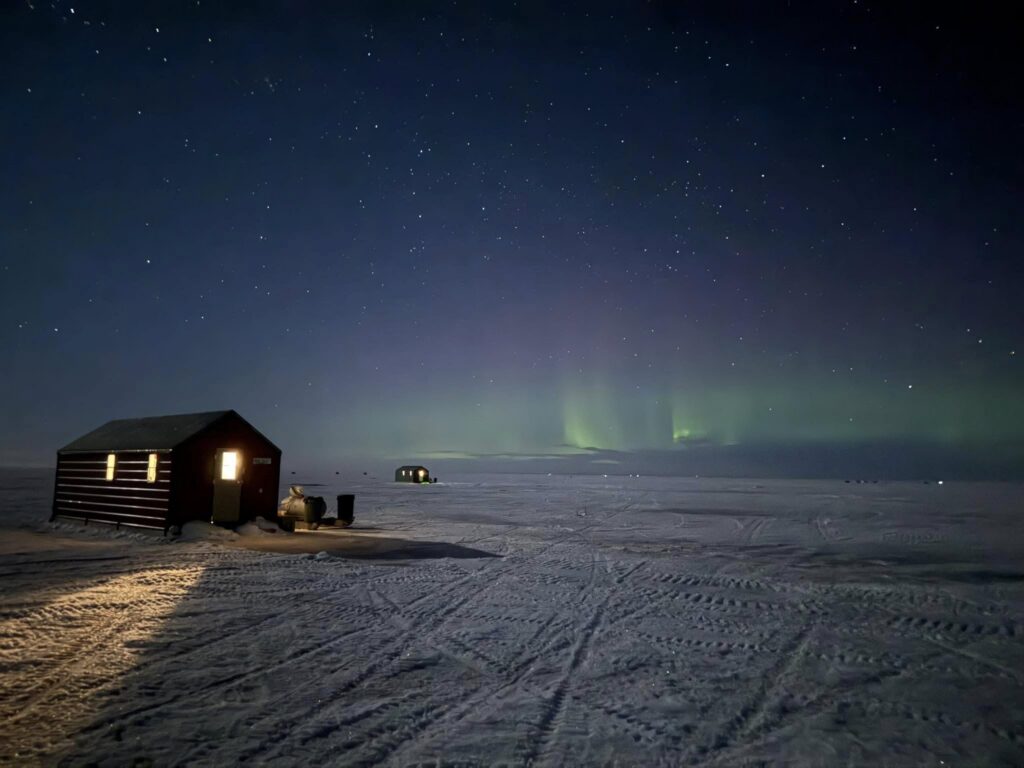 Fish house under the northern lights, Arnesen's Rocky Point, Lake of the Woods MN ice fishing