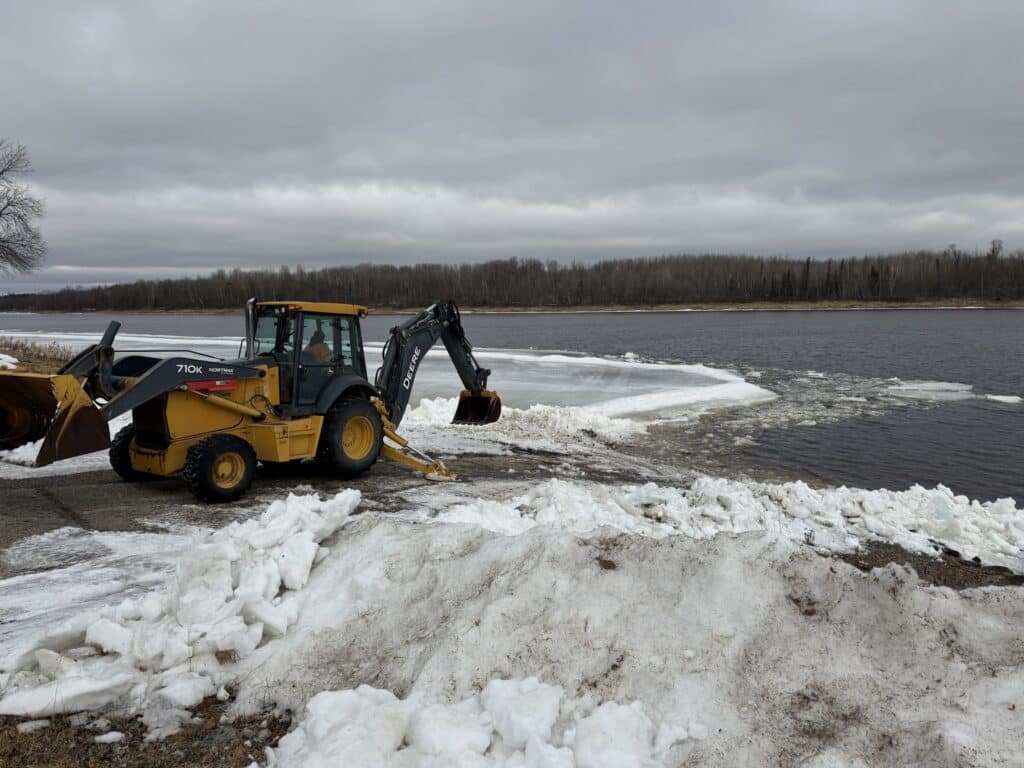 Backhoe opening up Nelson Park in Birchdale, MN on the Rainy River, spring fishing. 032626