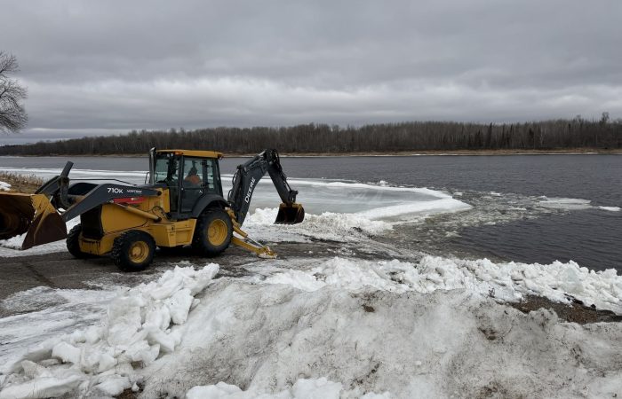 Backhoe opening up Nelson Park in Birchdale, MN on the Rainy River, spring fishing. 032626