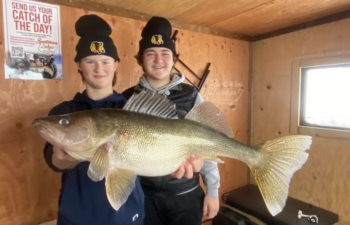 Boys with big walleye in fish house_Sportsmans Lodge_121624