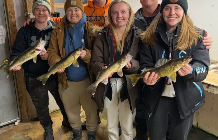 Ladies with walleyes in fish cleaning shack_Seans Birchview Resort_021725