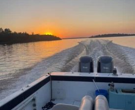 Lake of the Woods Passenger Service charter boat running at sunset