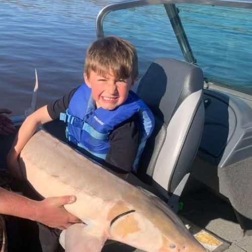 Ollie with albino sturgeon from Rainy River